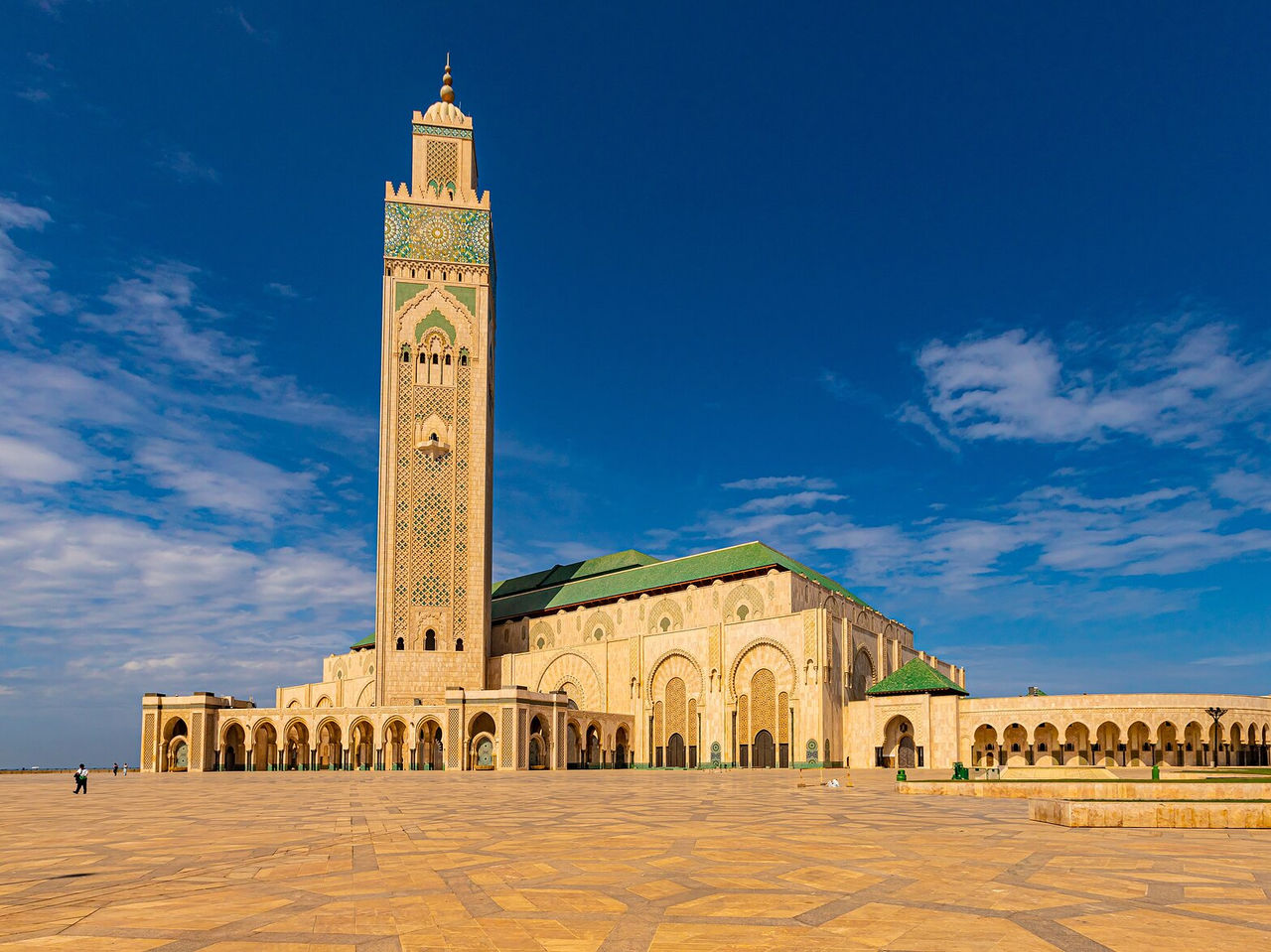 Hassan II Mosque in the city center, during the day with green roofs