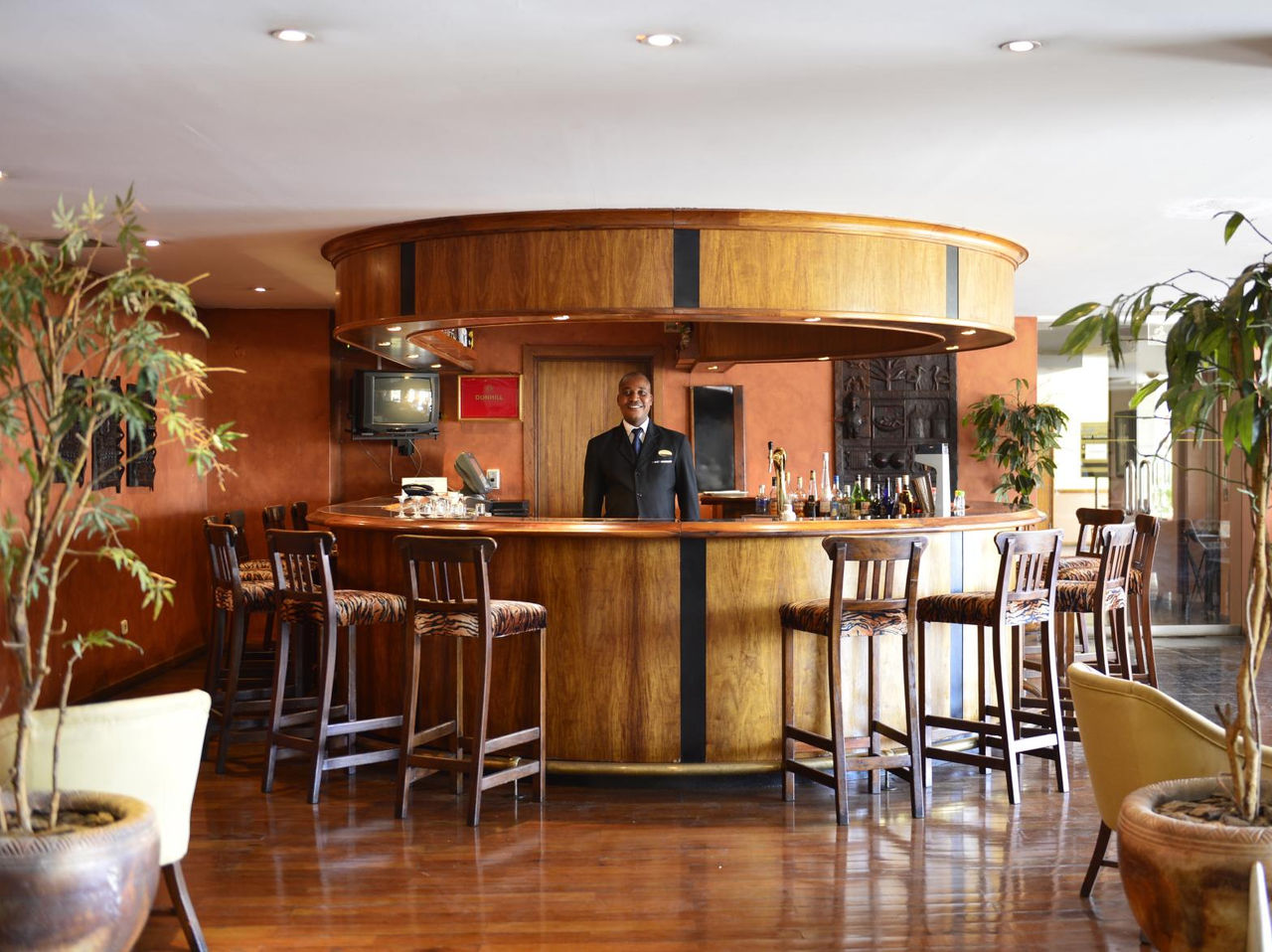 Sasseka Bar at a 4-Star Hotel in Maputo, with high chairs and serves a variety of alcoholic and non-alcoholic drinks