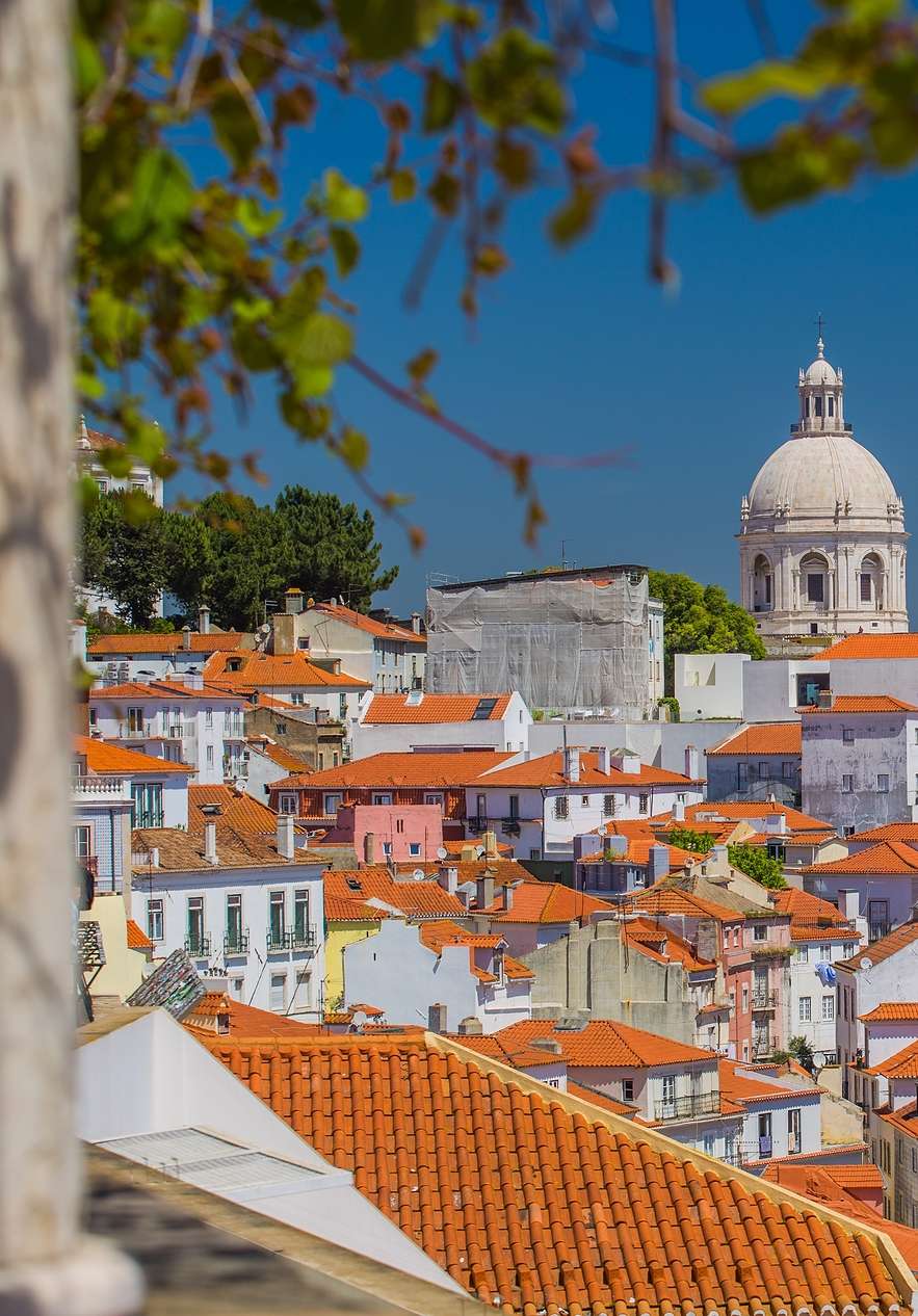 Alfama neighborhood in Lisbon with several colorful buildings of various heights and styles showcasing the city's history