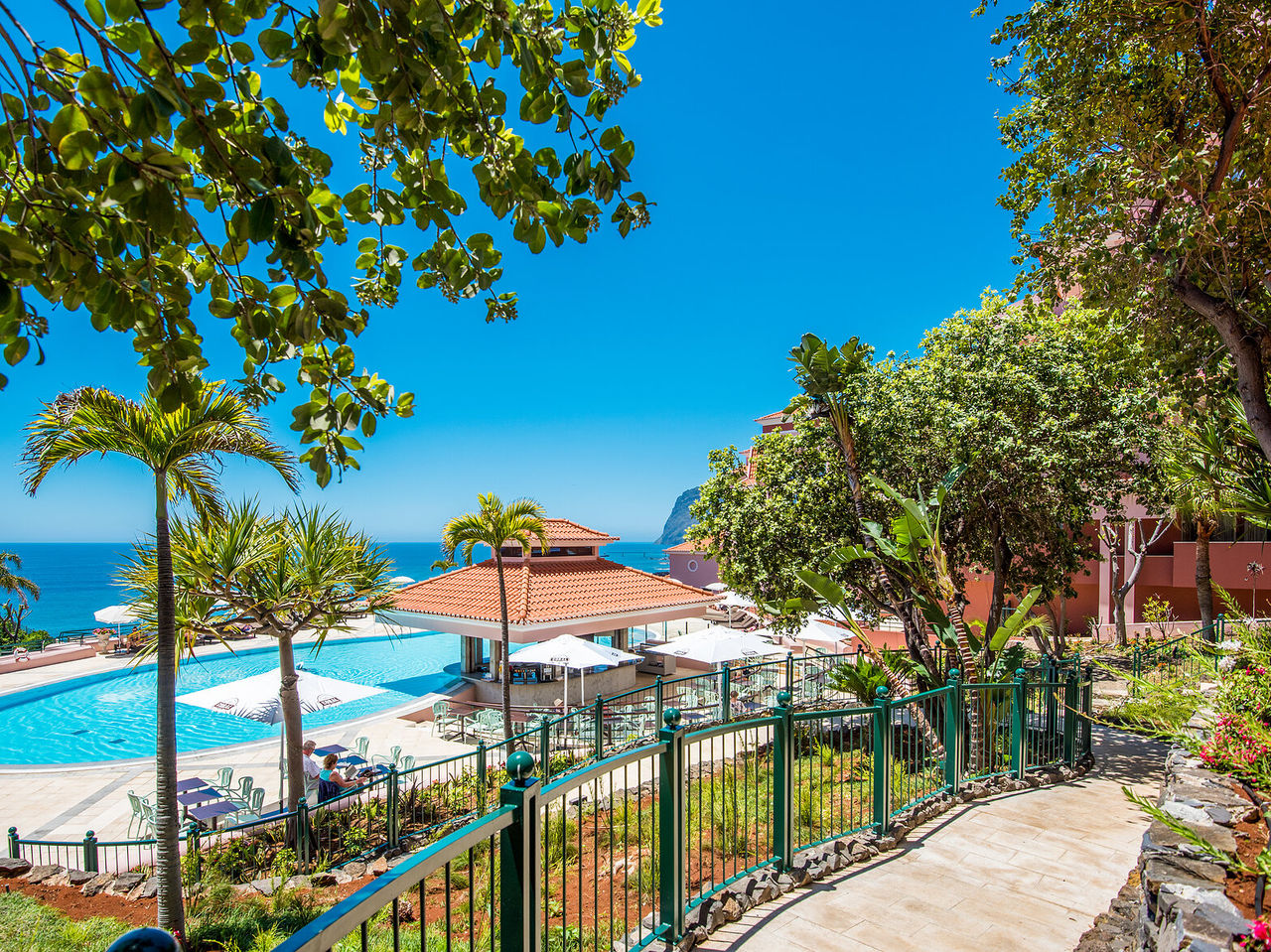 The Sunset Pool Bar, at the 5-Star Hotel in Funchal, includes a bar by the outdoor pool, with tables and umbrellas
