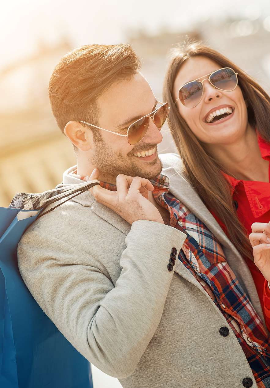 Smiling couple shopping on Oscar Freire Street a street of luxury shops and elegant boutiques in São Paulo