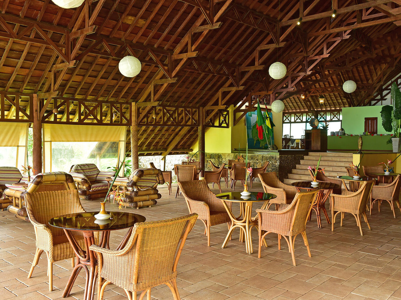 Le restaurant Golfinho, de l'hôtel à Ilhéu das Rolas, São Tomé, est extérieur avec tables en rotin