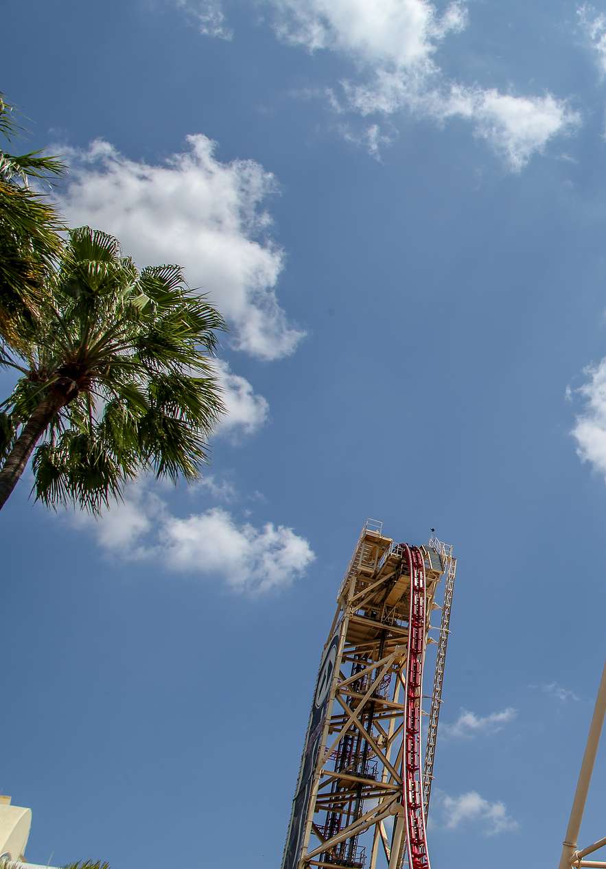 View from below of a roller coaster at Disney theme park in Orlando with people aboard the cart