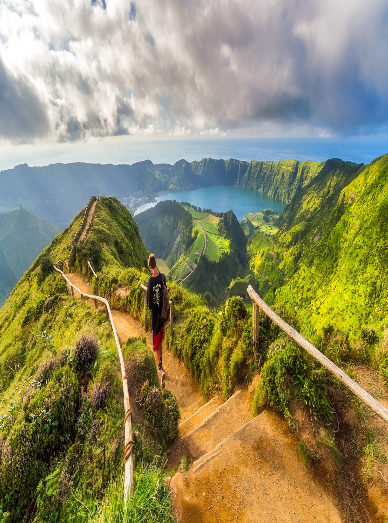 Man loopt op een zandpad met uitzicht op de Lagoa das Sete Cidades, São Miguel Island, Azoren