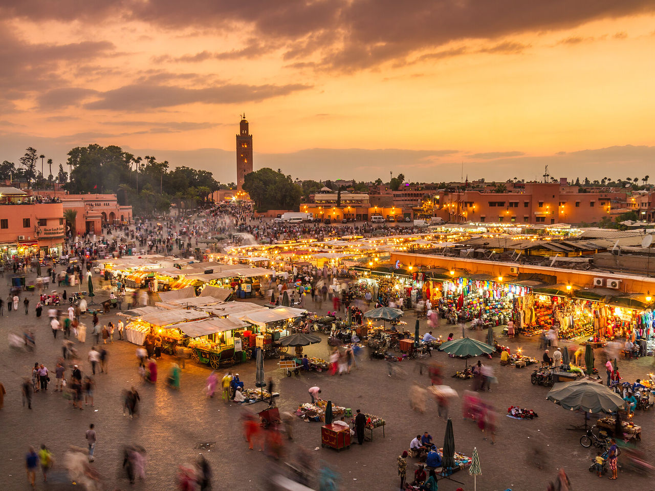 Top view of the main square in the historic center of Marrakech, at night, with lit tents and small shops