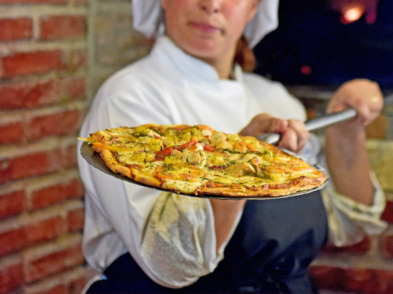 The Le Baron Restaurant at 4-Star Hotel in São Tomé has a chef making cheese and mushroom pizza