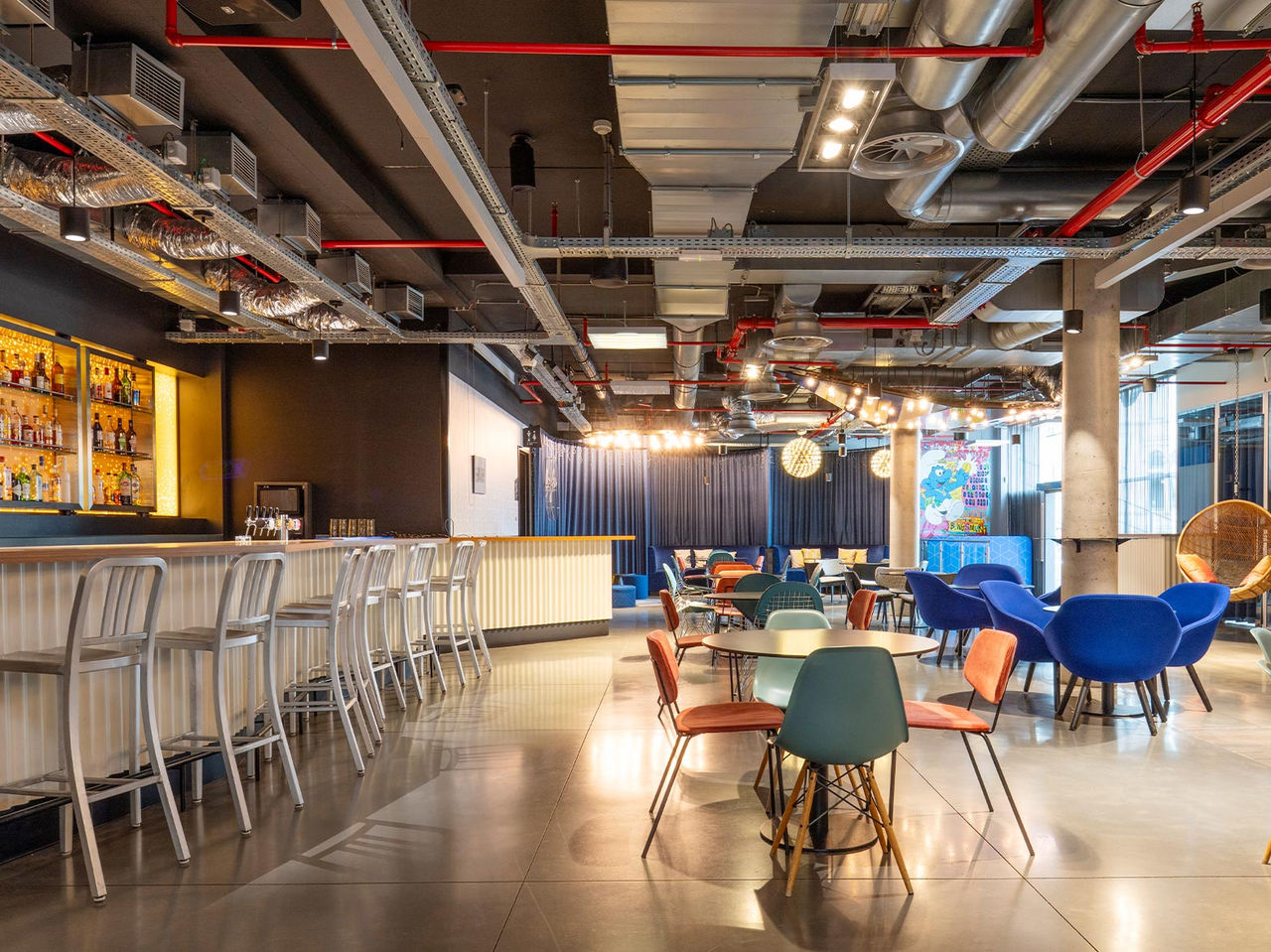 The hotel bar in Brussels near the European Parliament has chairs, tables, and hanging swings