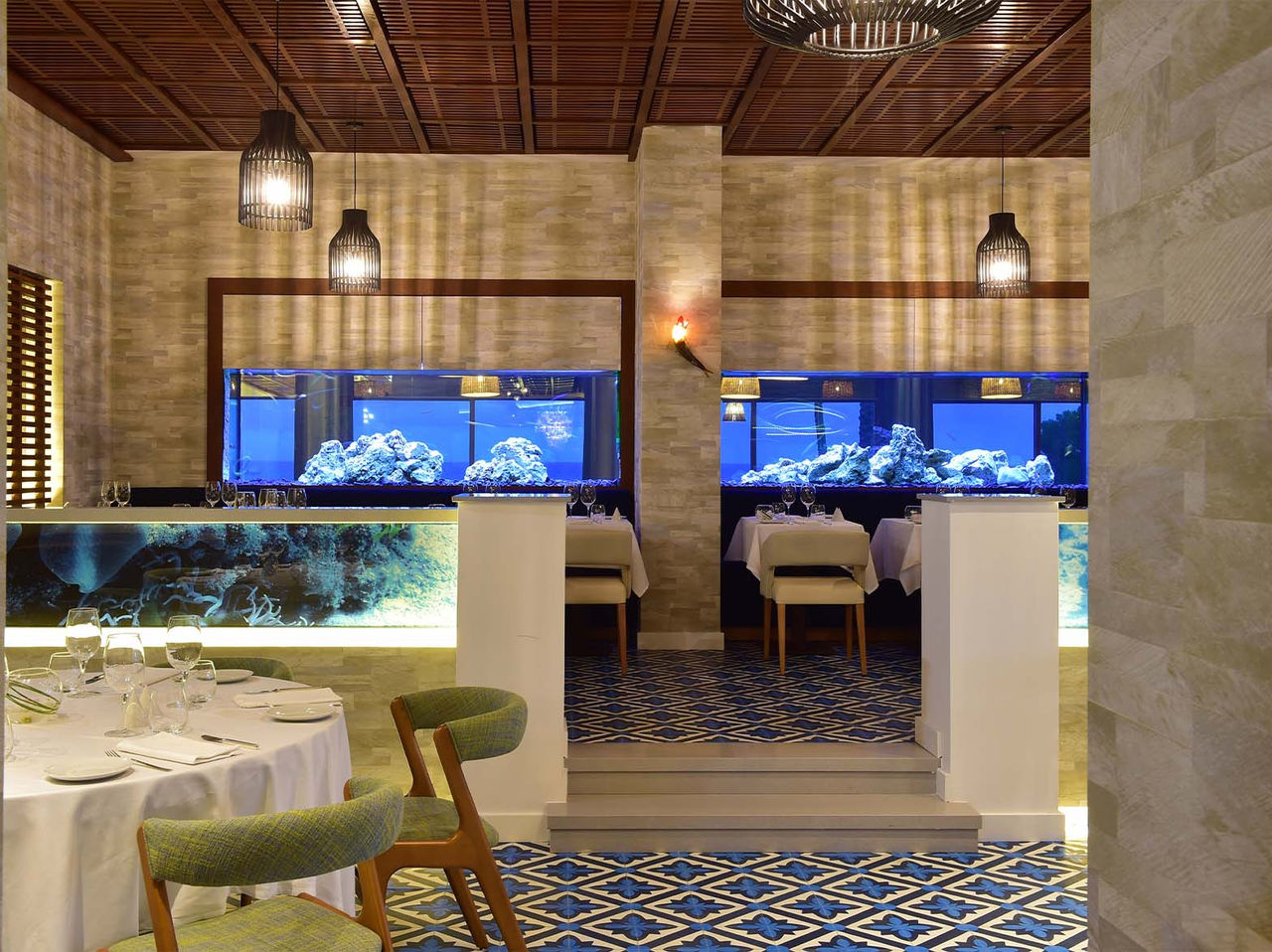 Sul features aquariums, ceiling lights, and cushioned chairs