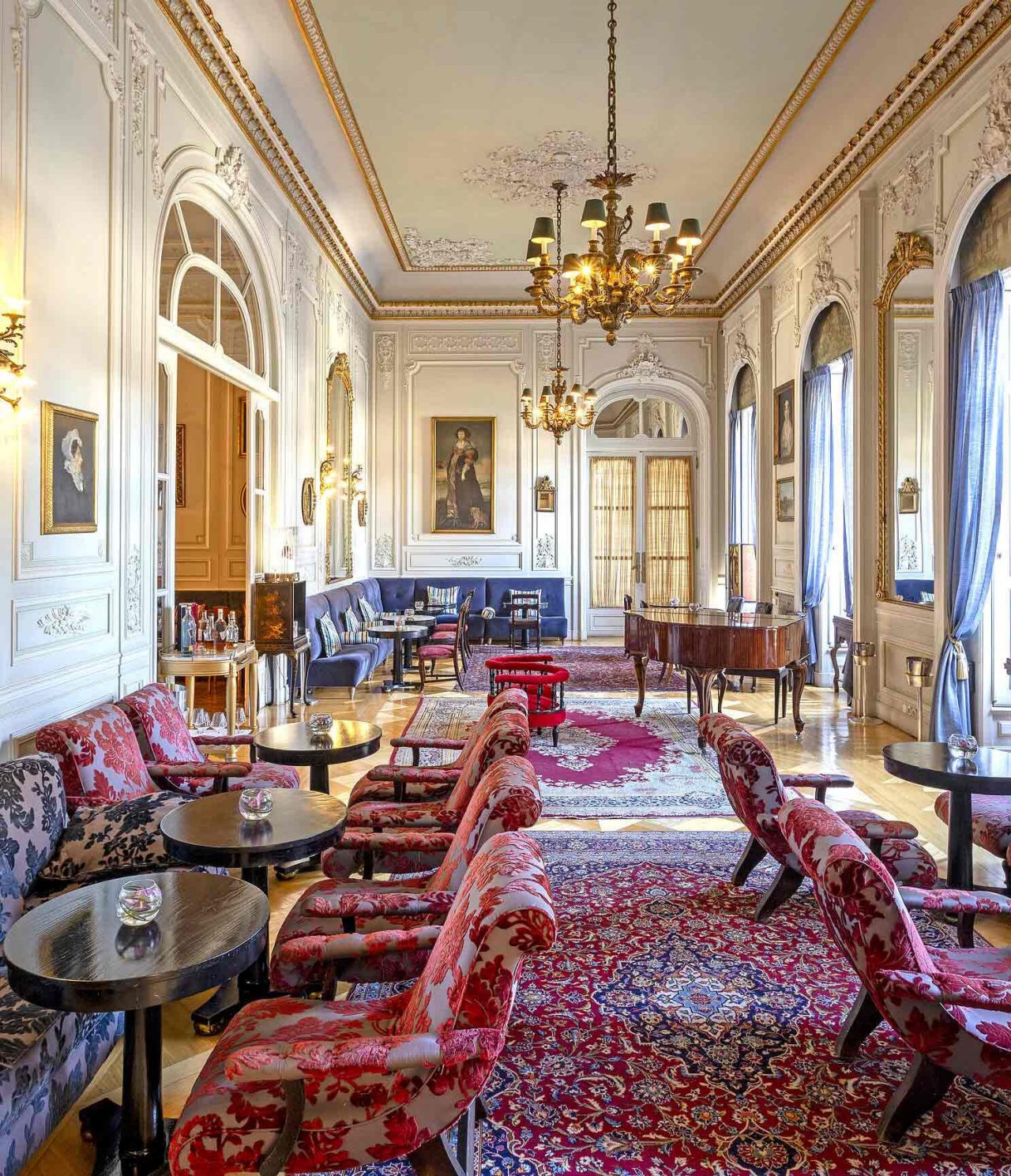 The Allegro bar at the 5-star hotel and National Monument, Pestana Palace Lisboa, has sofas, tables, chairs, and a piano