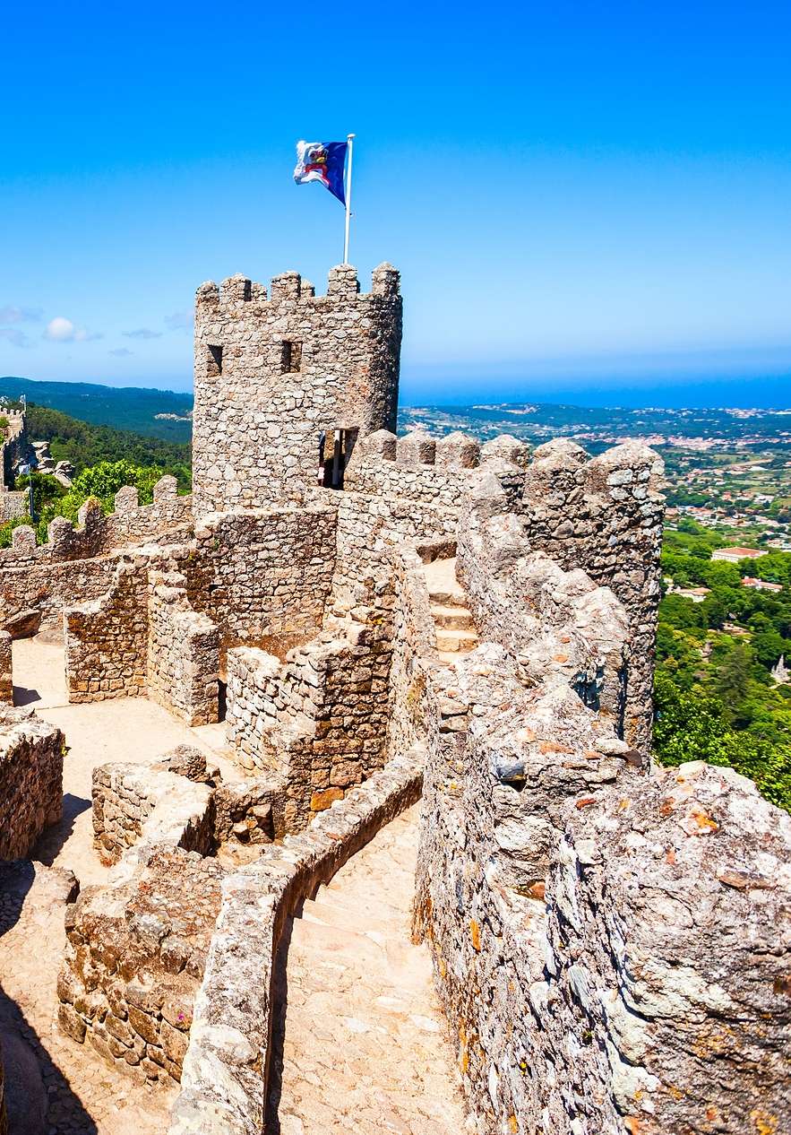 Panoramic view of the Moorish Castle in Sintra with stone walls towers and the wonderful surrounding landscape