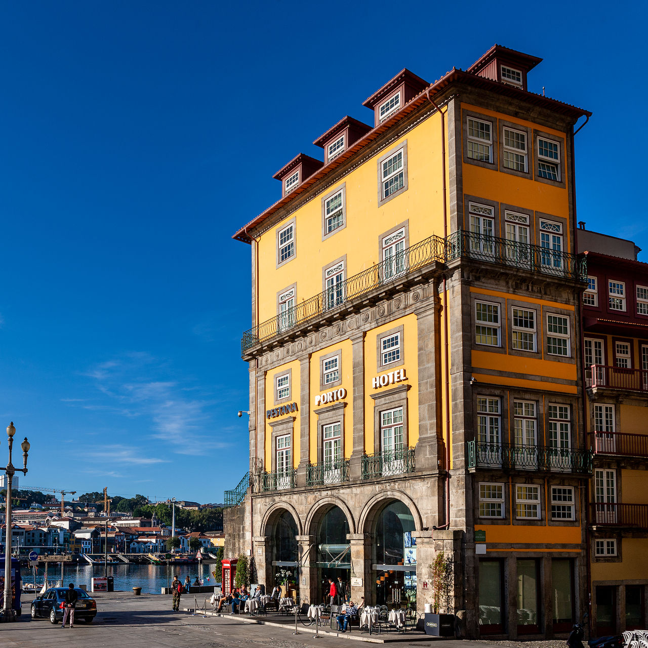 Yellow exterior building of Pestana Vintage Porto, a 5-star hotel in the city center by the riverside