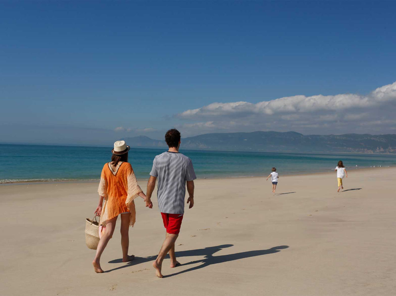 Family walking along the beach of Tróia, at Pestana Tróia Eco Resort, a hotel of the Pestana Residences brand